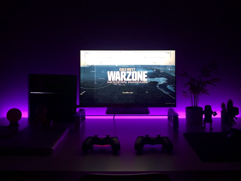 Console gaming lounge with large OLED screen and couches
